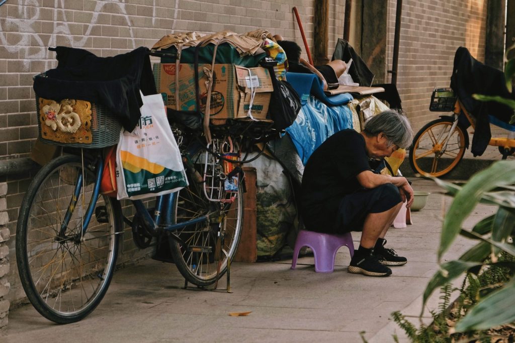 woman in black shirt sitting on purple plastic chair